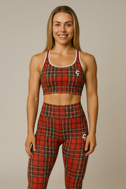 Woman wearing a red plaid sports bra and shorts in a gym setting