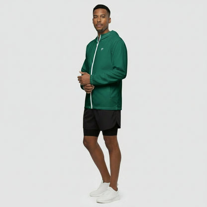 Man wearing a green jacket and black shorts on a white background