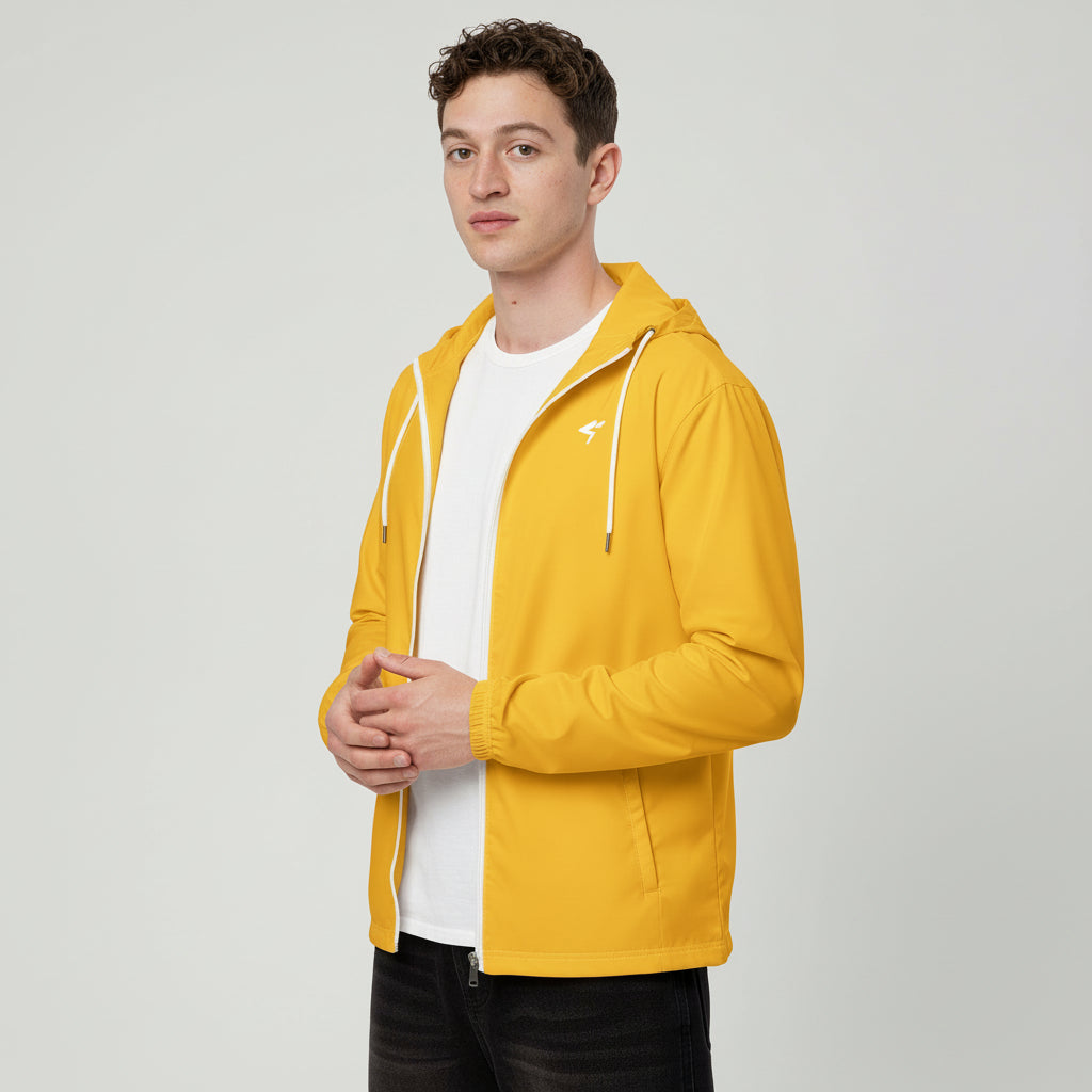 Man wearing a yellow jacket over a white shirt on a white background