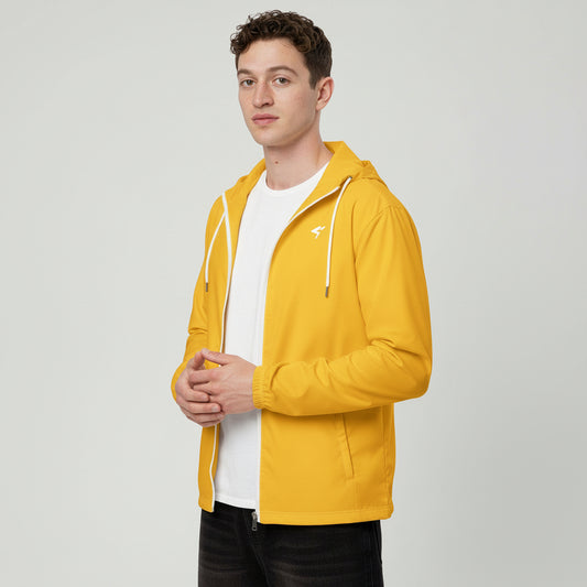 Man wearing a yellow jacket over a white shirt on a white background