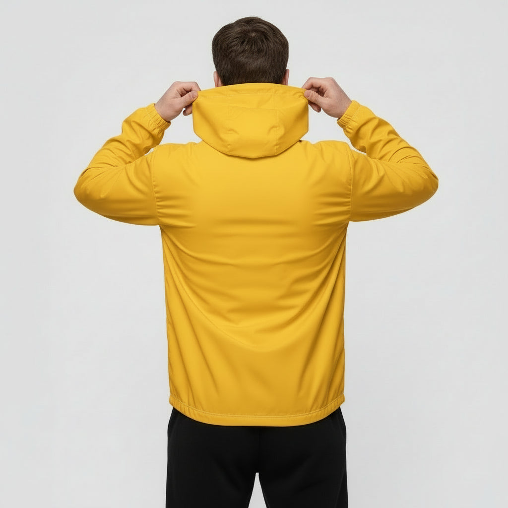 Person wearing a yellow jacket with the hood up on a plain background