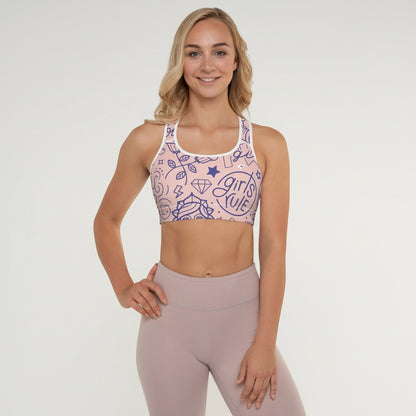 Woman wearing a sports bra and leggings with a plain background