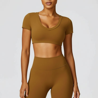 Person wearing a brown athletic outfit on a light gray background