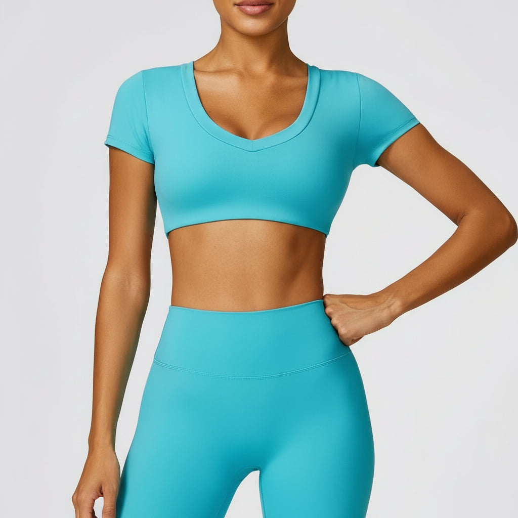 Person wearing a turquoise athletic outfit on a light gray background