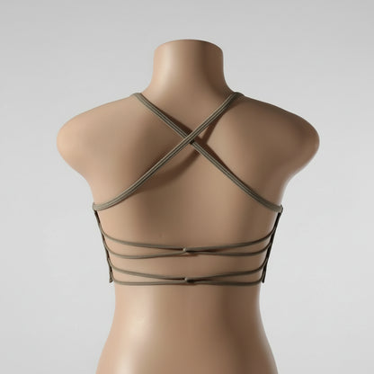 A woman wearing a white seamless sports bra and green Activewear leggings.