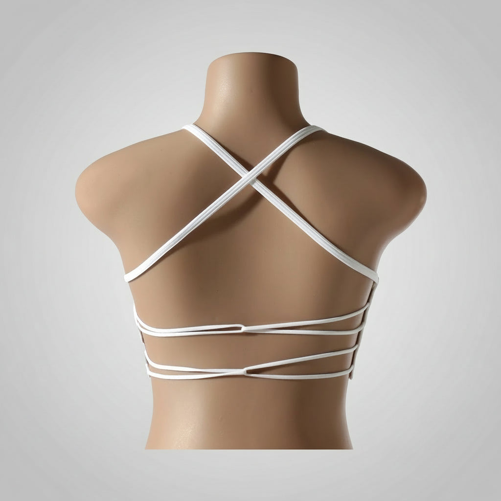 A woman wearing a white seamless sports bra and green Activewear leggings.