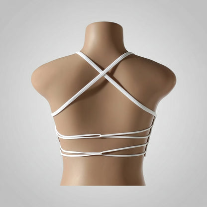 A woman wearing a white seamless sports bra and green Activewear leggings.