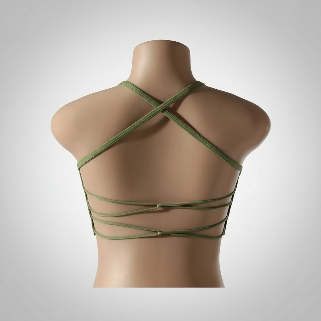 A woman wearing a white seamless sports bra and green Activewear leggings.