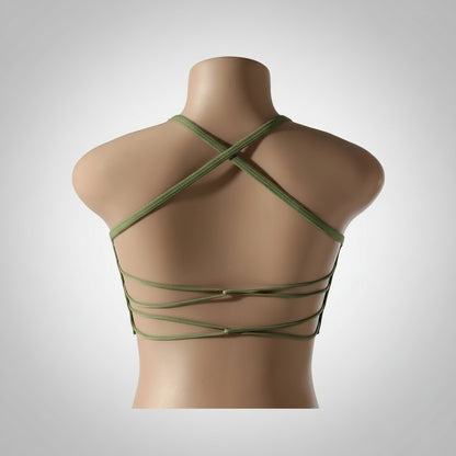 A woman wearing a white seamless sports bra and green Activewear leggings.