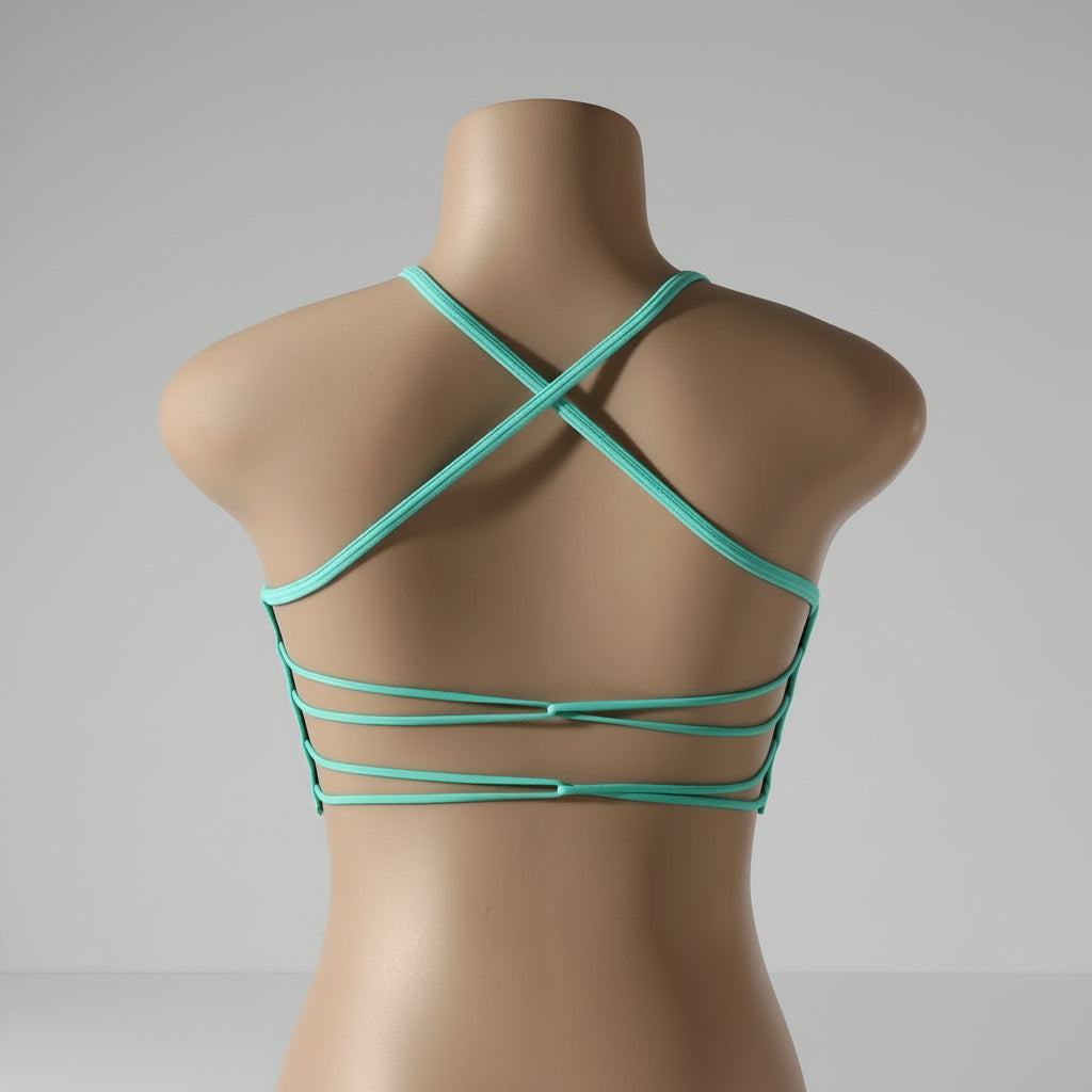 A woman wearing a white seamless sports bra and green Activewear leggings.