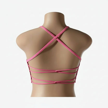 A woman wearing a white seamless sports bra and green Activewear leggings.