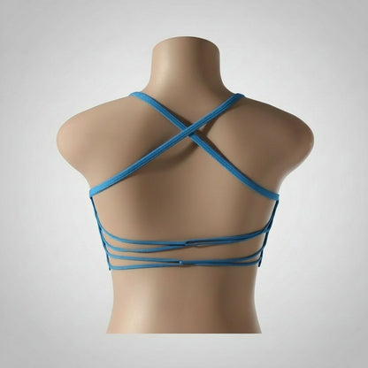 A woman wearing a white seamless sports bra and green Activewear leggings.