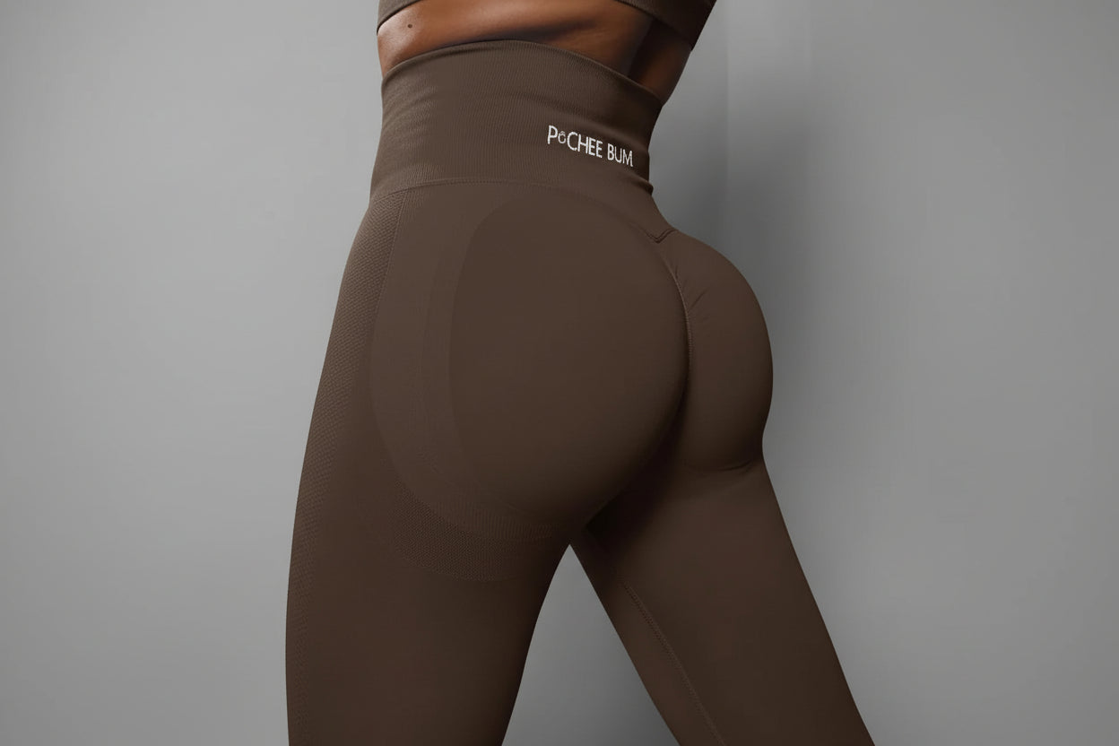 Brown leggings with 'Pochee Bum' logo on a dark background