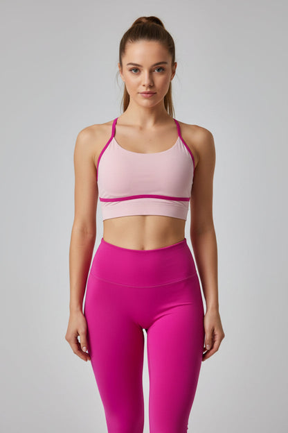 Pink sports bra and leggings set on a light gray background