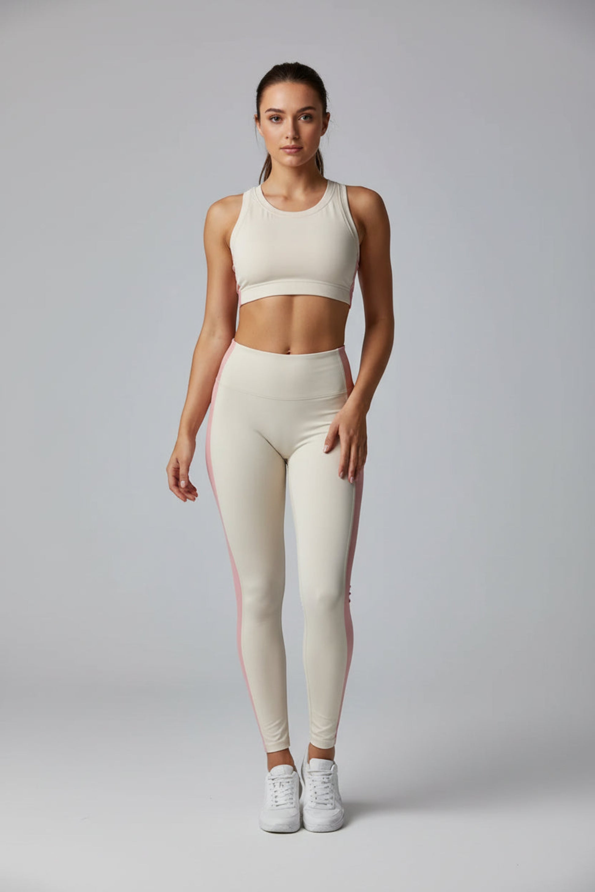 Beige tank top and leggings set on a gray background