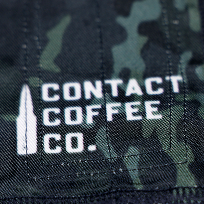 Black and green camo wrist wrap with white Contact Coffee Co. logo text