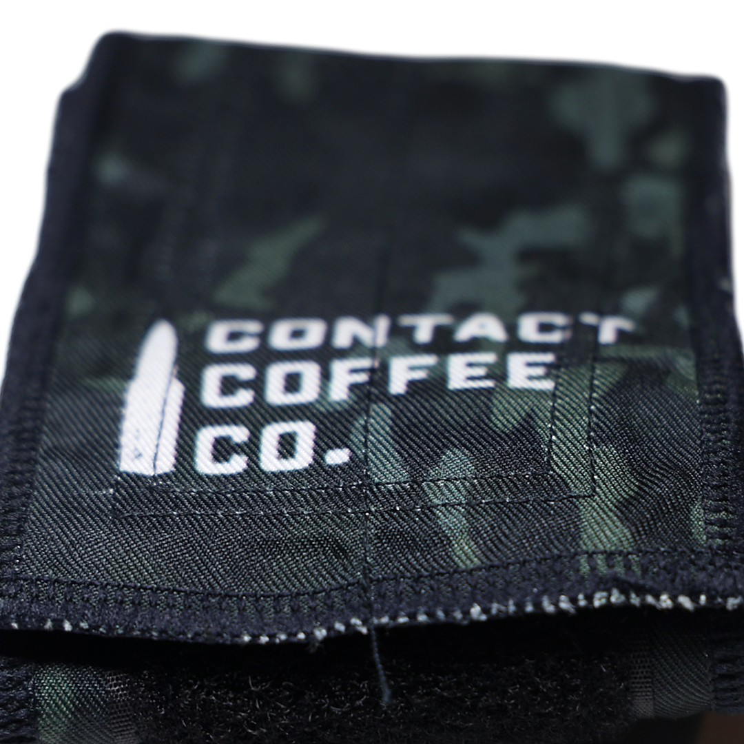 Black and green camo wrist wrap with Contact Coffee Co. logo and stitched edge