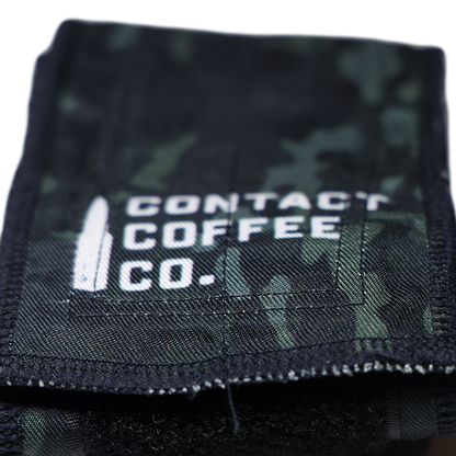 Black and green camo wrist wrap with Contact Coffee Co. logo and stitched edge