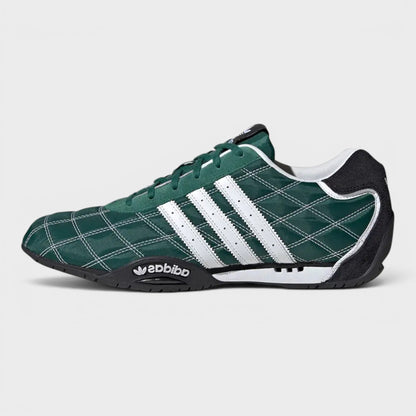 Green low-top Adidas sneakers, profile view with white triple stripes and lace-up