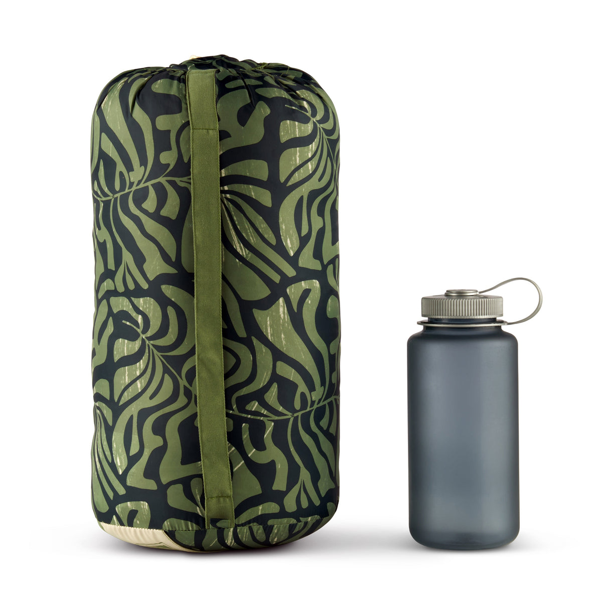 Cylindrical rolled camping blanket with leaf-pattern fabric and carry loop, with bottle