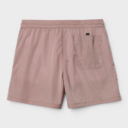 Pink swim trunks with elastic waist and side cargo pocket, black logo tag