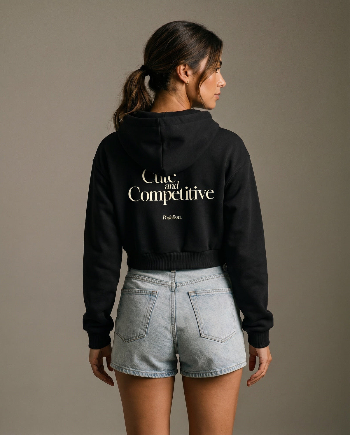 Black cropped hoodie with hood and large back logo text.