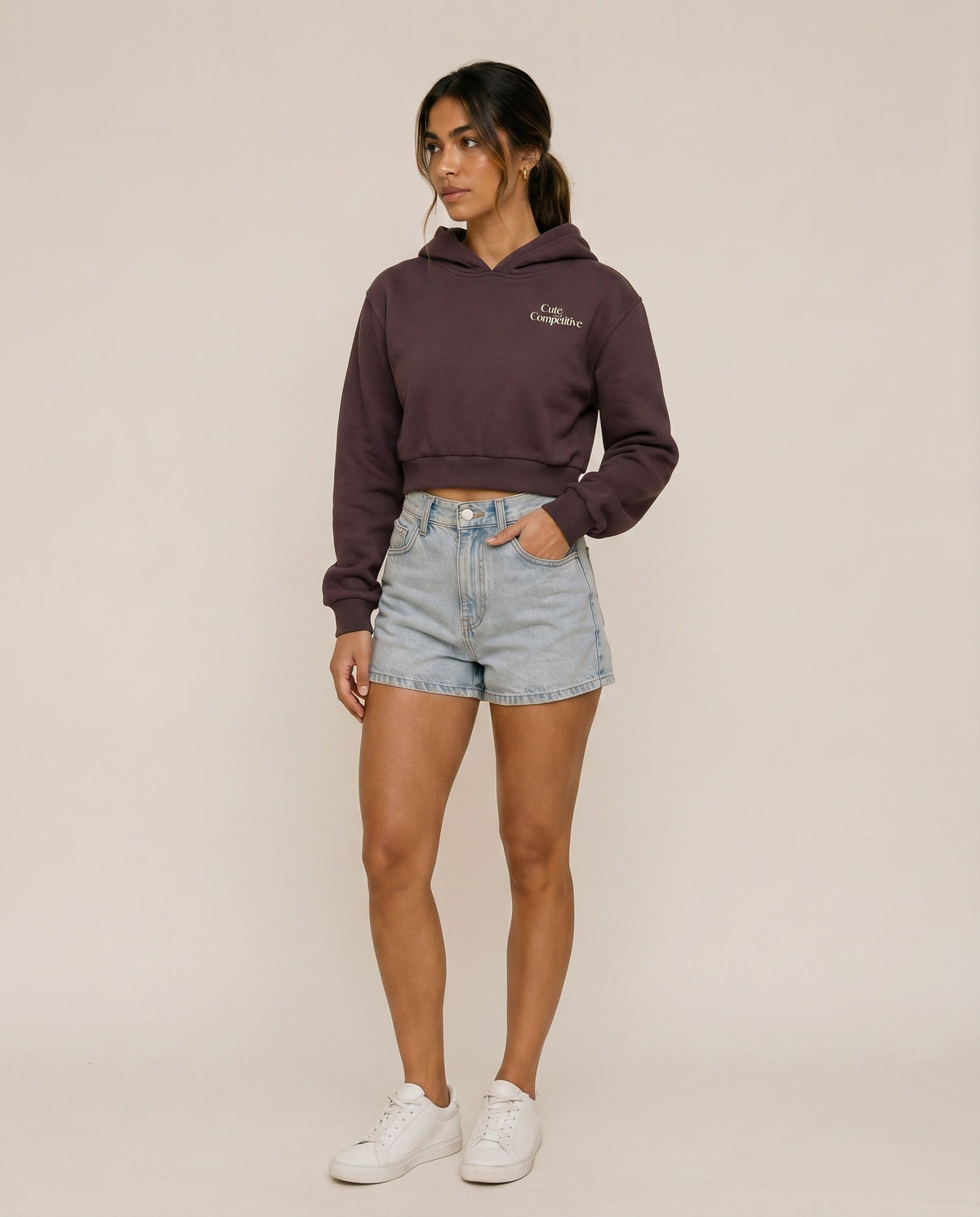 Dark purple cropped hoodie with hood, front logo, and kangaroo pocket
