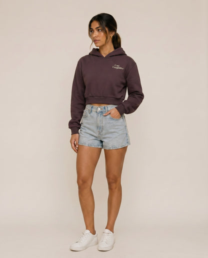 Dark purple cropped hoodie with hood, front logo, and kangaroo pocket