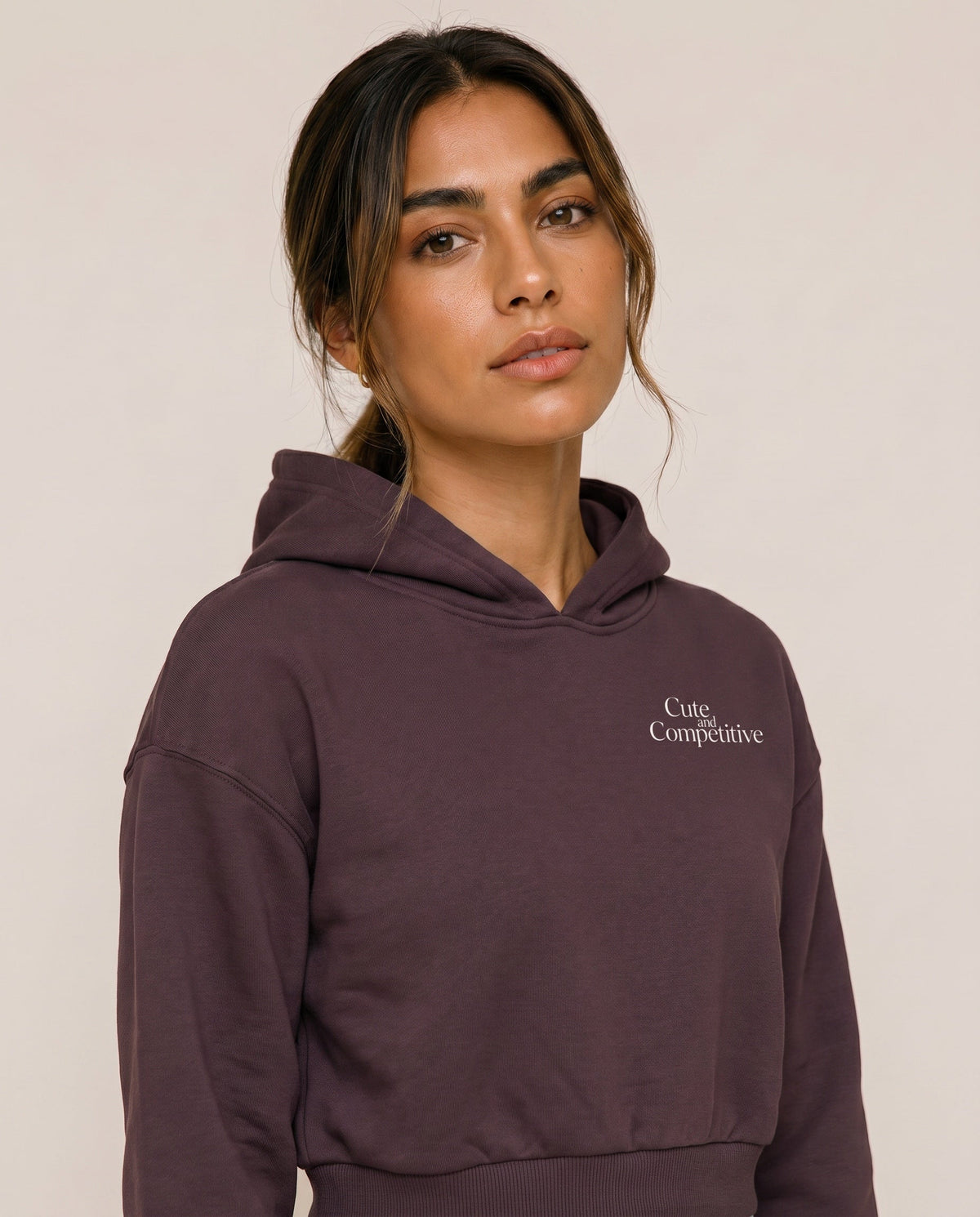 Dark purple cropped hoodie with hood and small chest logo
