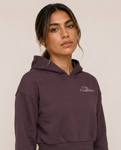 Dark purple cropped hoodie with hood and small chest logo