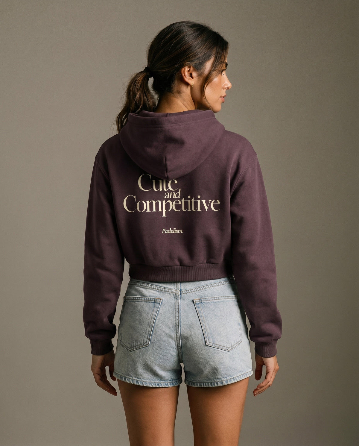 Dark purple cropped hoodie with hood and large printed back slogan