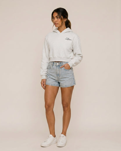 Light gray cropped hoodie with hood, kangaroo pocket, and small chest logo.