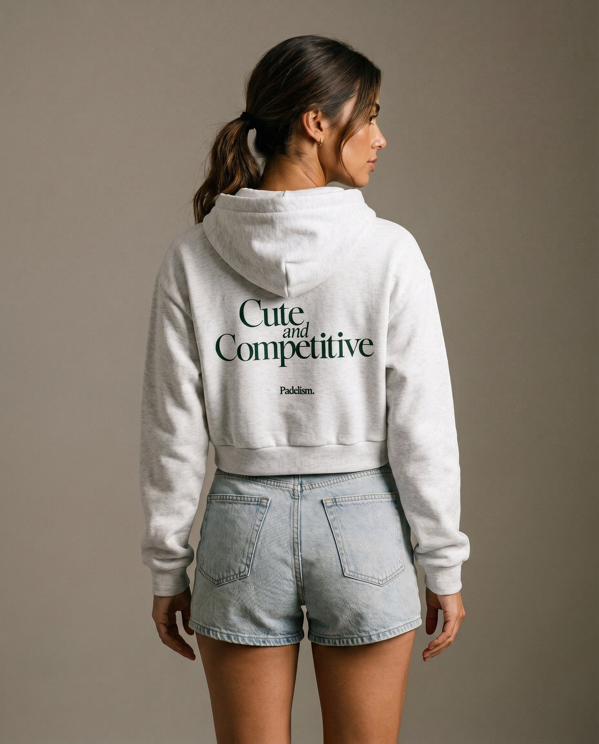 Light gray cropped hoodie with hood, long sleeves, and printed back slogan