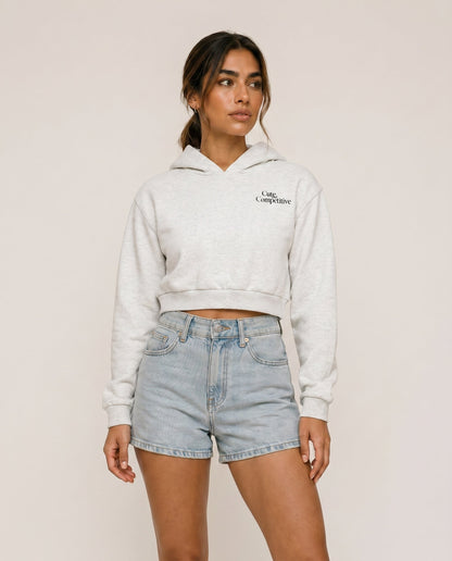 Light gray cropped hoodie with hood, front logo, and kangaroo pocket