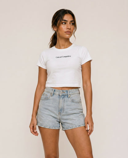 Cropped white T-shirt with crew neck and short sleeves; small chest slogan print