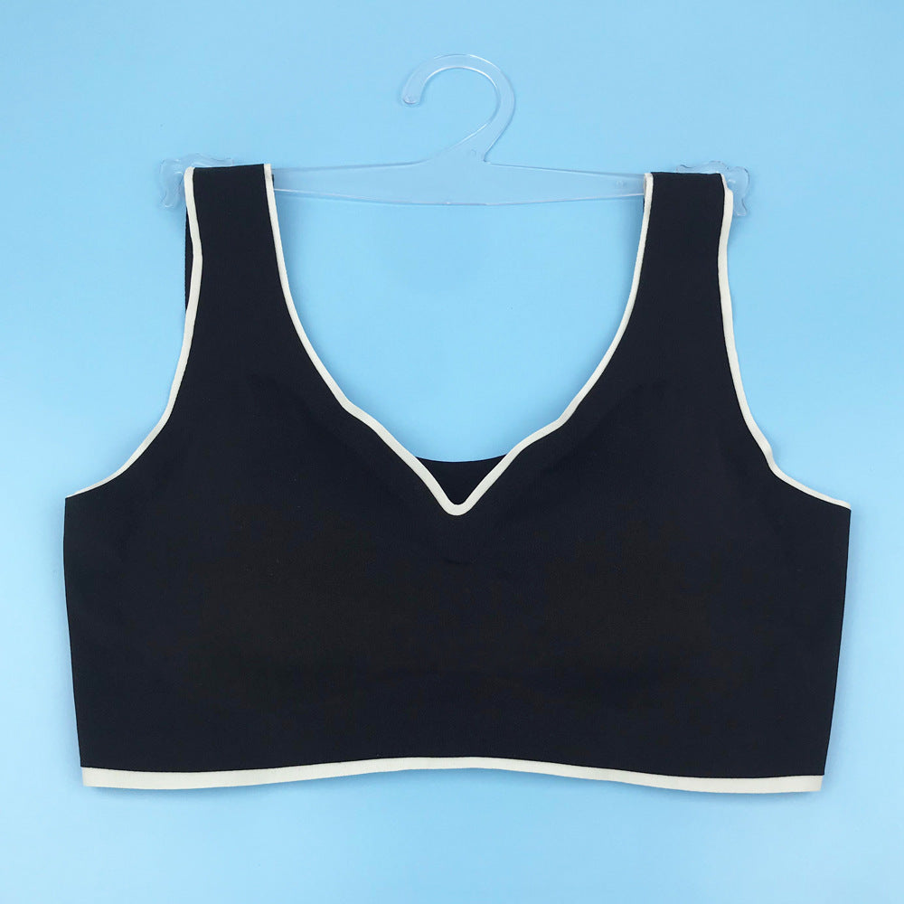 Seamless underwire-free bra in black with V-neck and contrast light trim