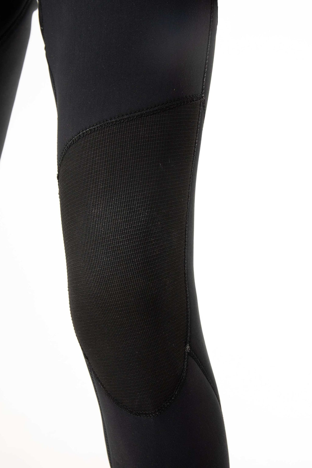 3/2mm steamer wetsuit leg close-up, dark textured fabric panel with seam detail