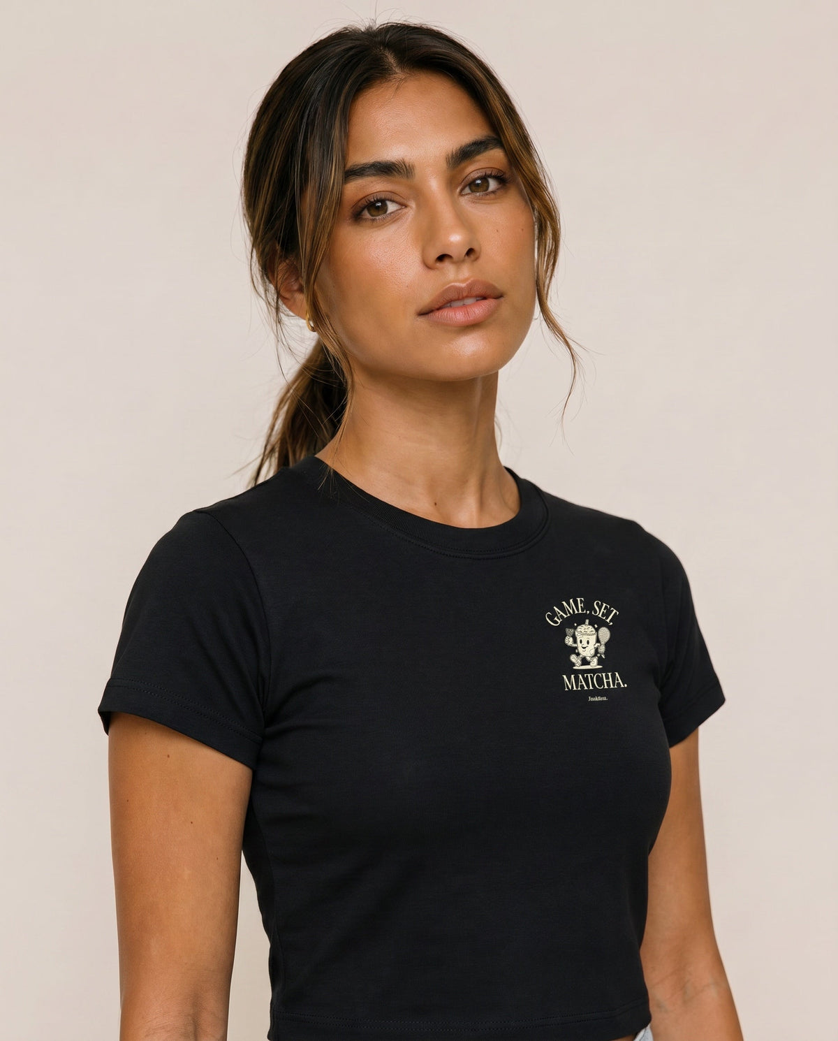 Black crewneck t-shirt close-up with "Game, Set, Matcha" logo on left chest.