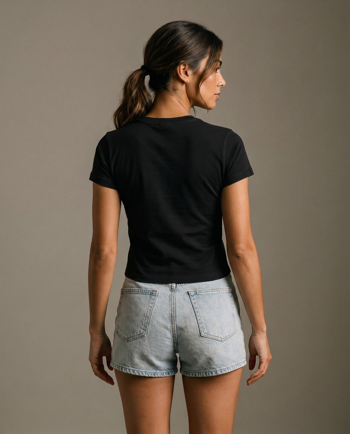 Black crewneck t-shirt back view with no visible logo, short sleeves.