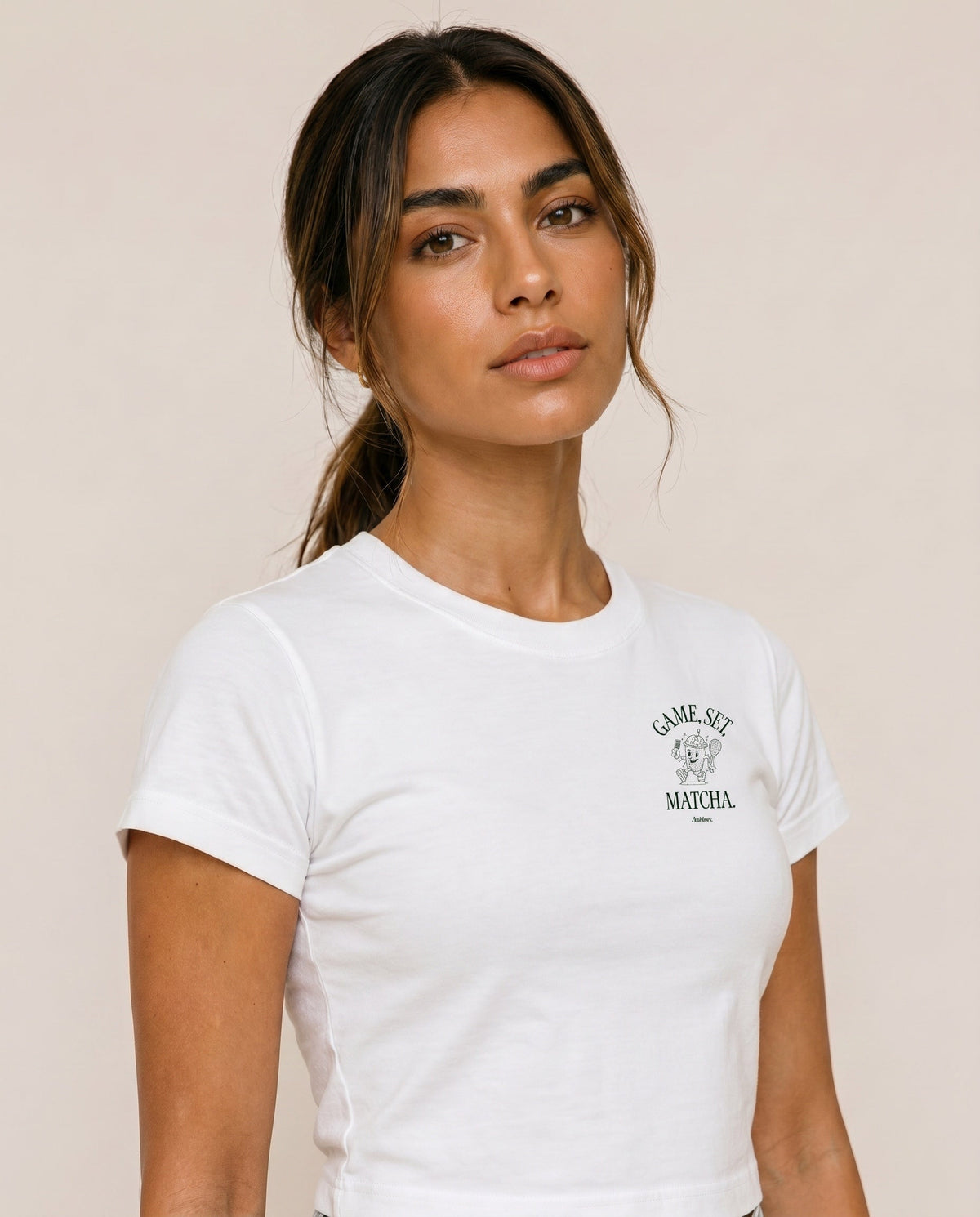 White crewneck T-shirt with chest logo print at center, short sleeves