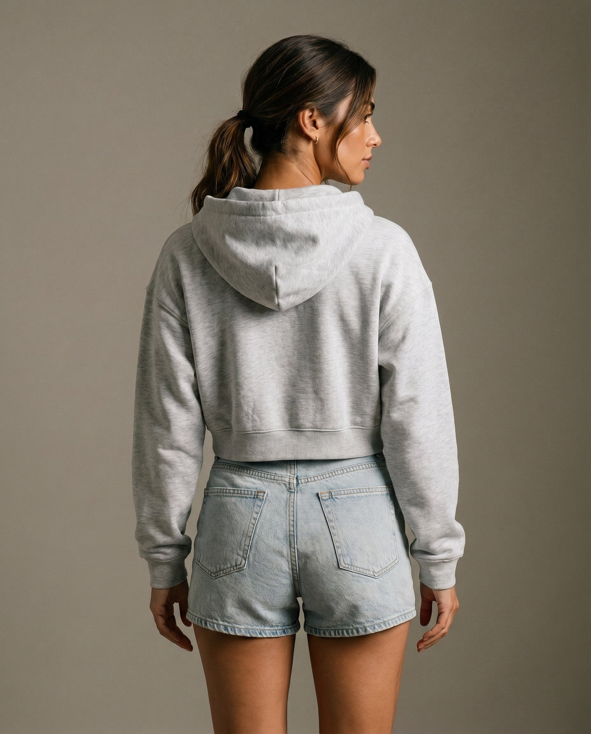 Light gray cropped hoodie from the back with hood and long sleeves.