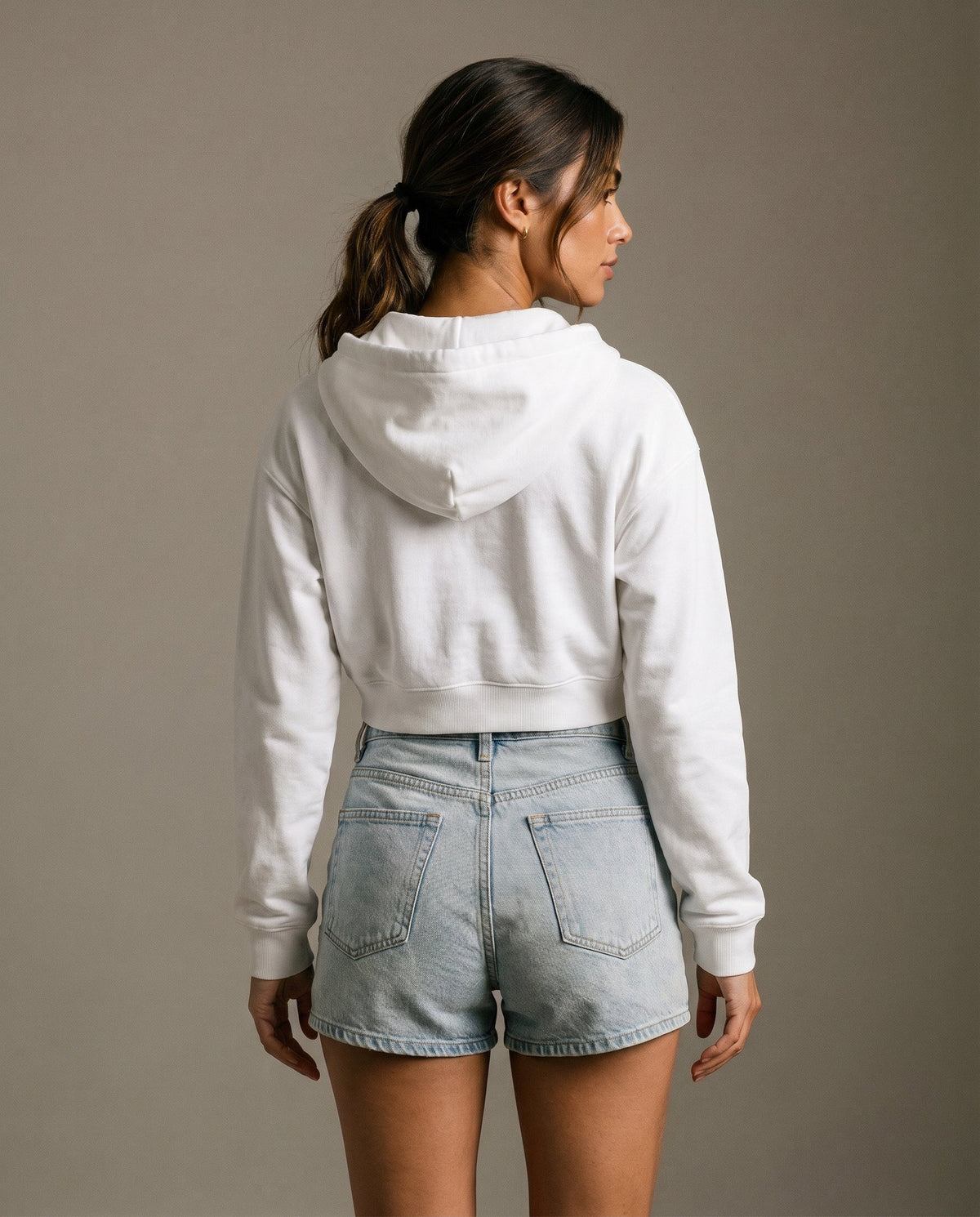Back view of cropped zip hoodie in white with hood and drawstring