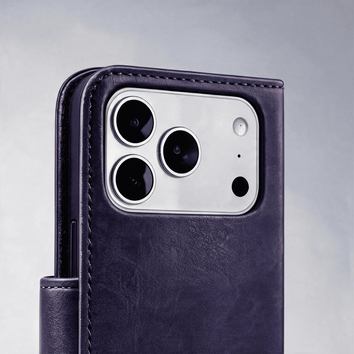 Purple leather-look wallet phone case with stitched edges and camera cutout