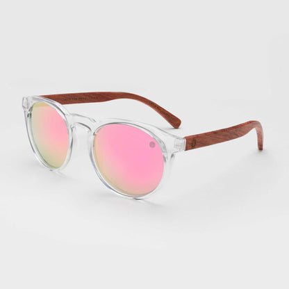 Round sunglasses with clear frame, pink tinted lenses, and brown wooden-style arms