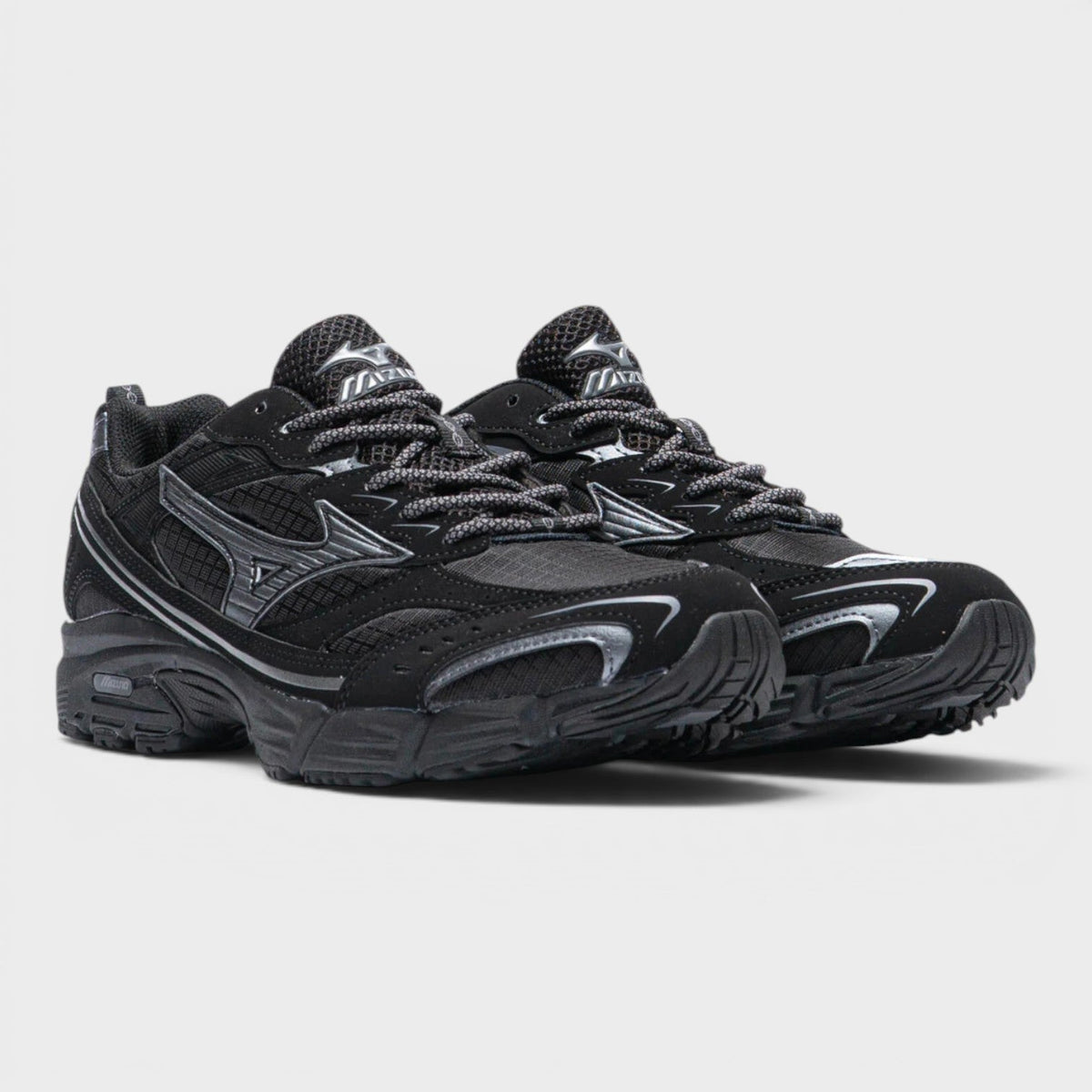Black lace-up sneakers with metallic side logo and textured upper, chunky sole