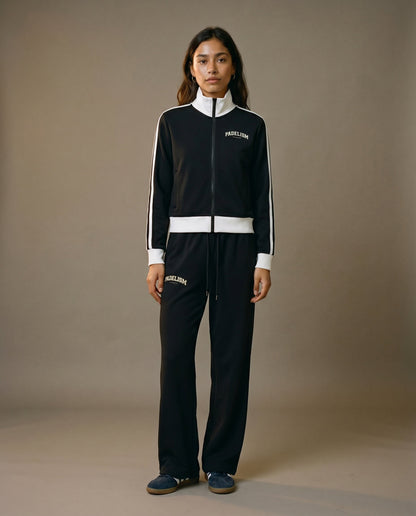 Black track jacket with white zipper, striped sleeves, and small chest logo