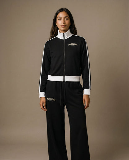 Black track jacket with white front zipper, striped sleeve panels, chest logo