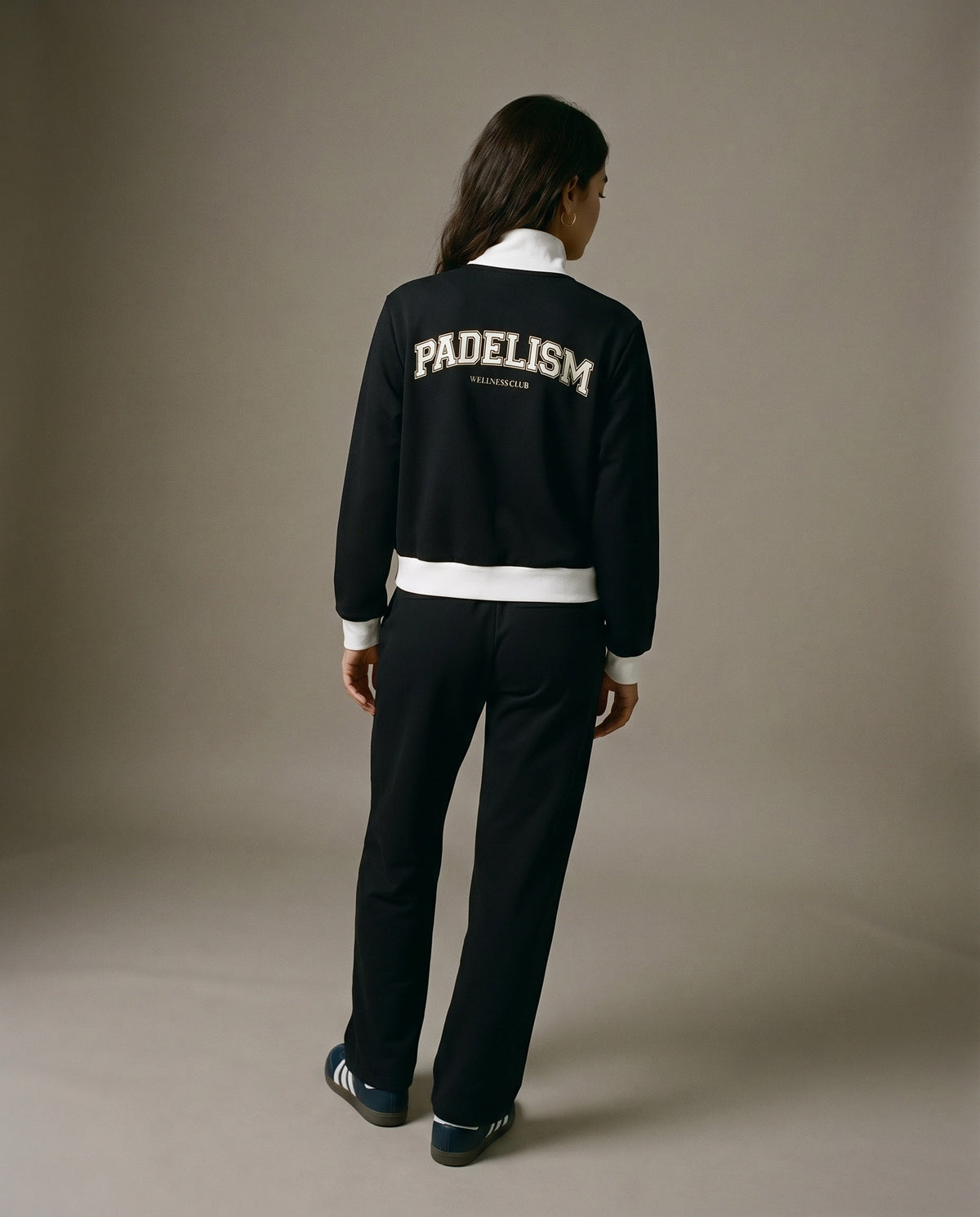 Black track jacket, back view, with large Padelism logo and white waist band