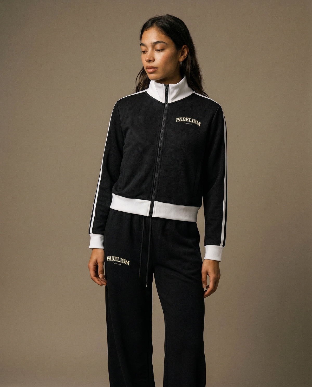 Black track jacket with white zipper, striped cuffs, and chest Padelism logo