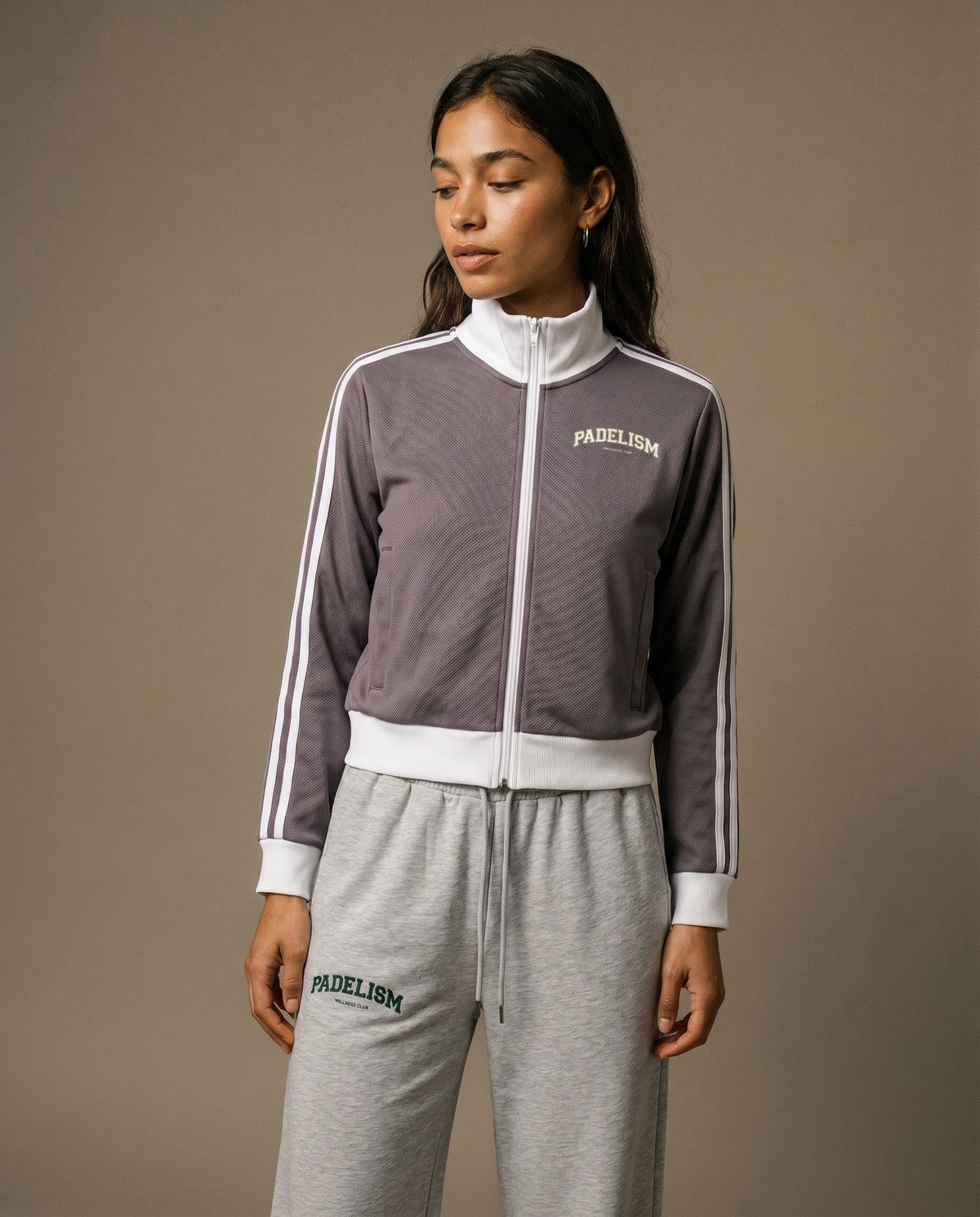 Plum purple track jacket with white zipper, striped sleeves, and chest logo
